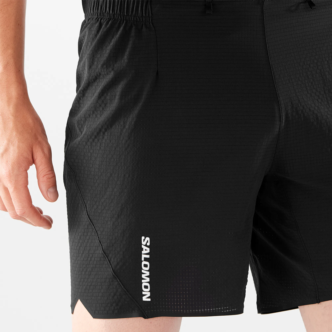 Black athletic shorts with a visible brand logo on a white background