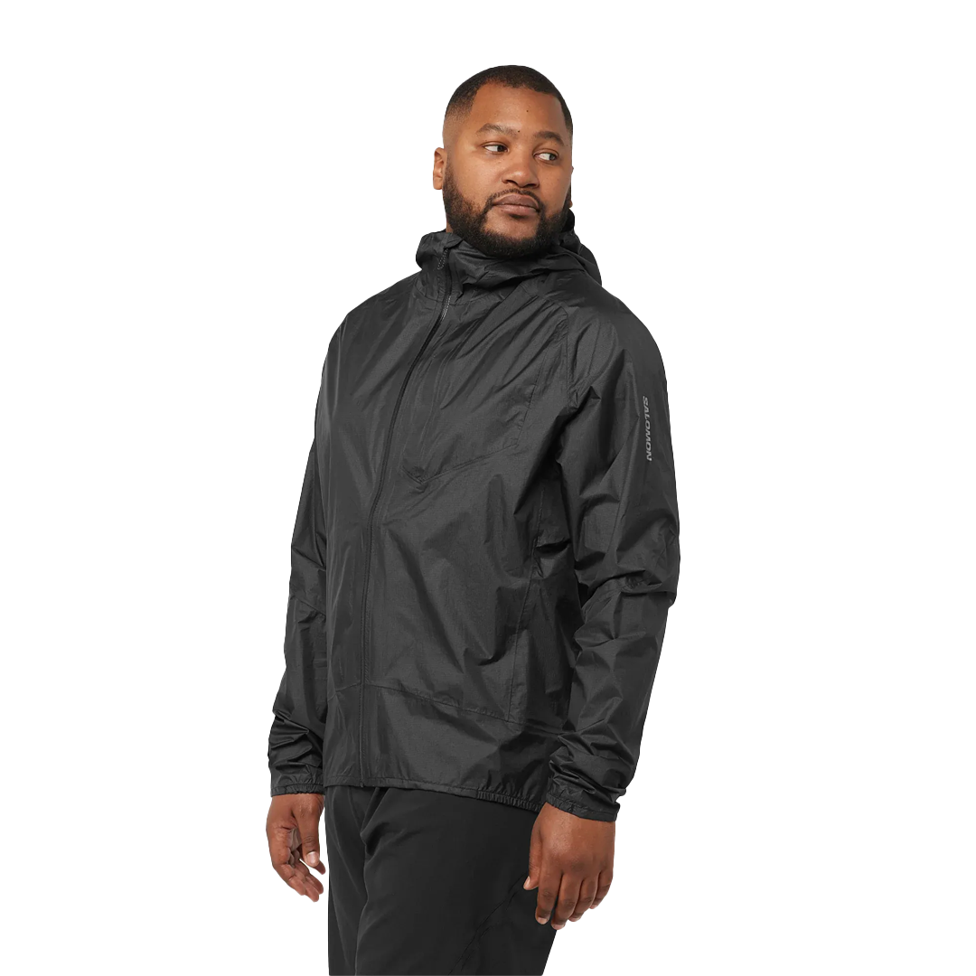 Man wearing a black rain jacket on a white background