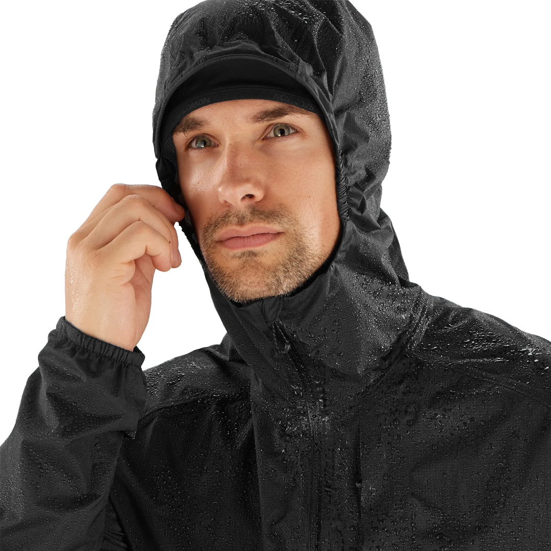 Man wearing a black raincoat on a white background